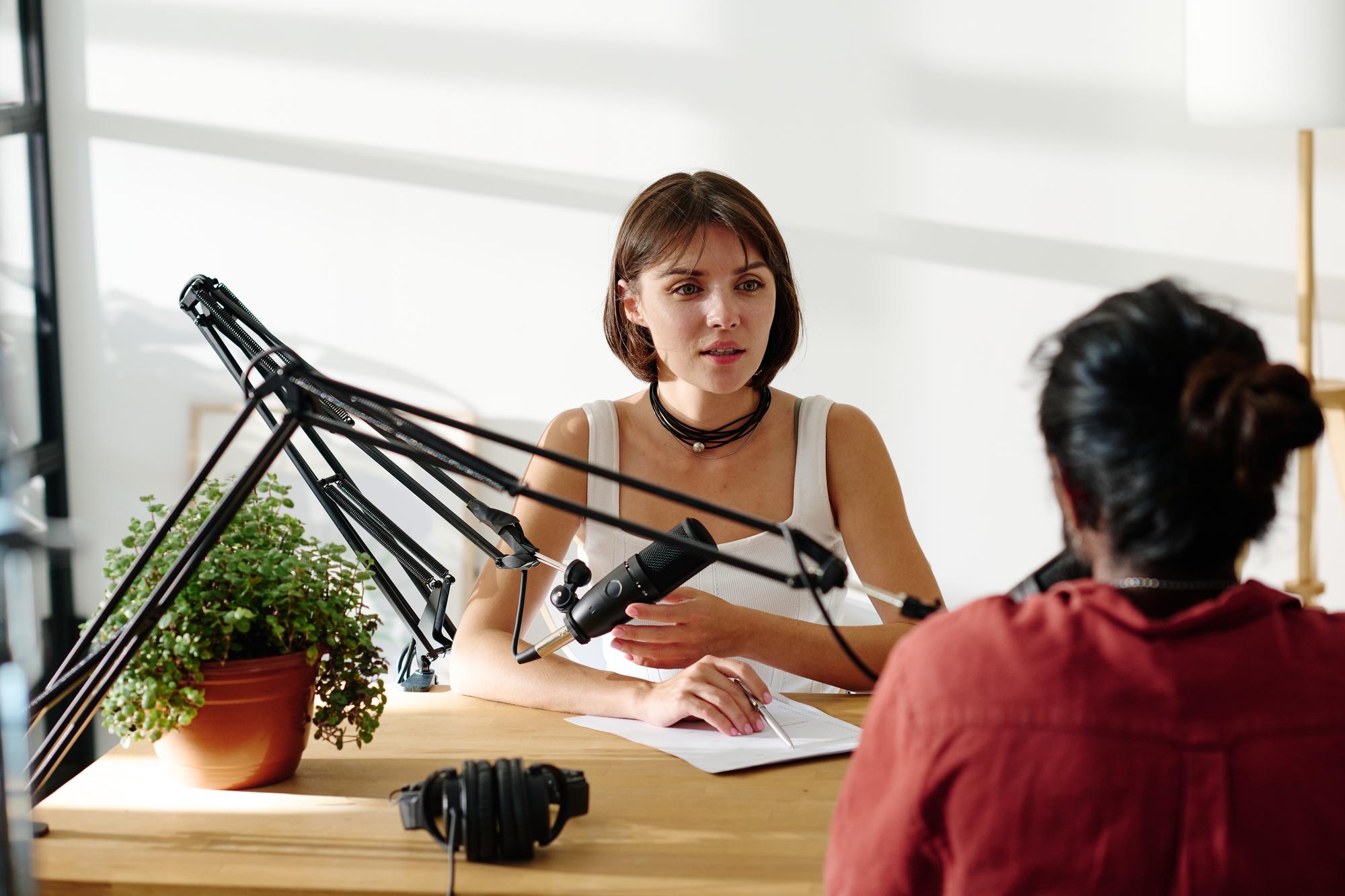 A journalist conducting an in-depth interview in a studio